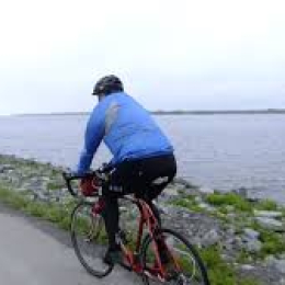 lone cyclist along lake Erie shoreline 